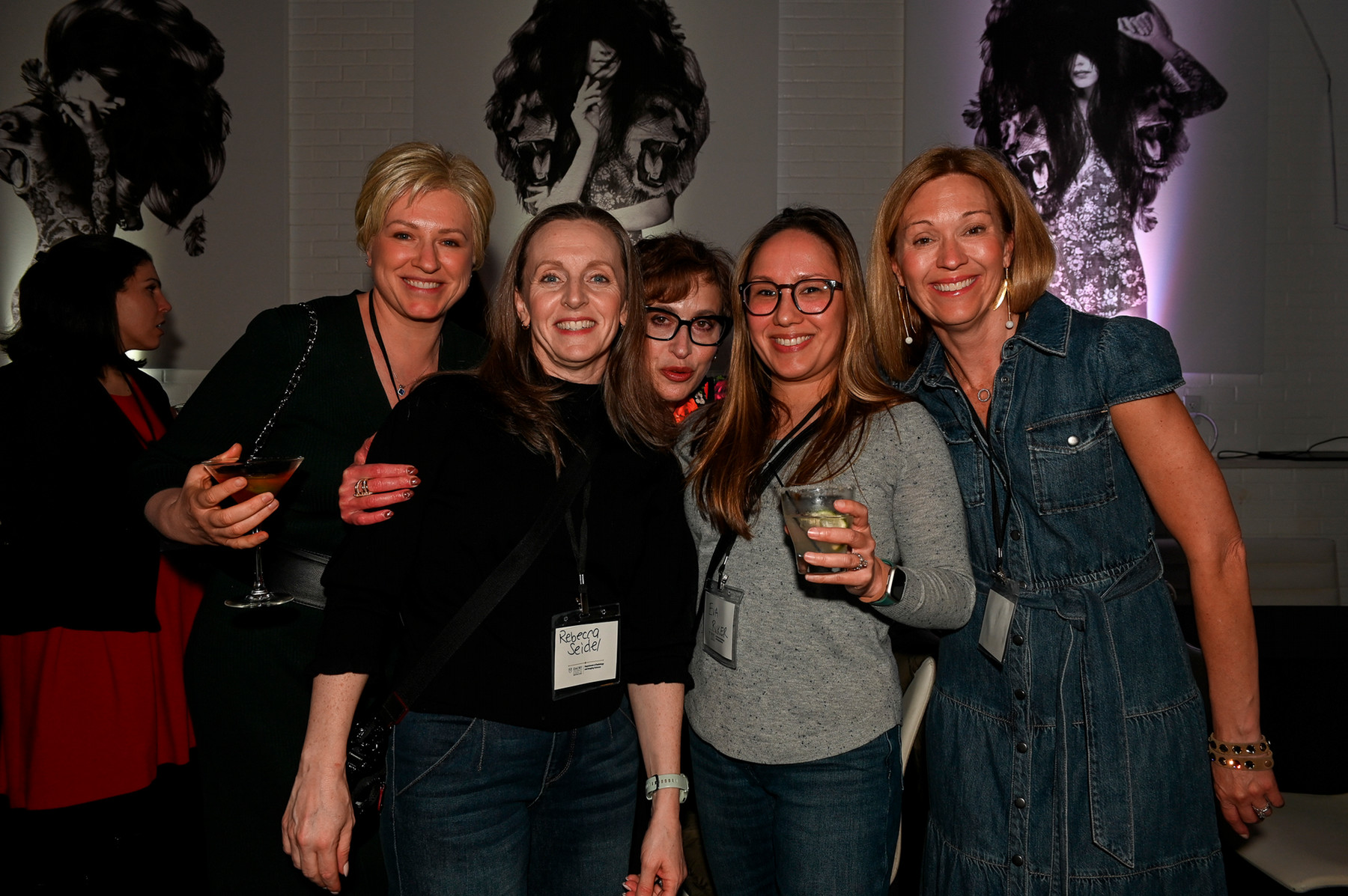 five smiling people together at a party